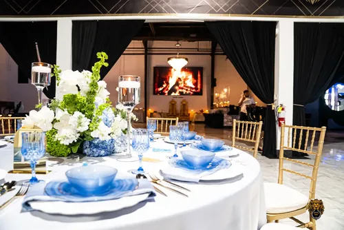 Reception tables with blue glassware and white flowers